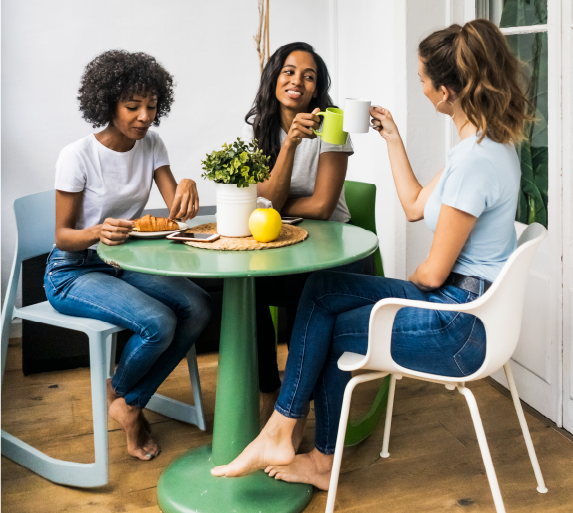 Three Women Enjoying Coffee at Evelyn's House - Building Connections and Support